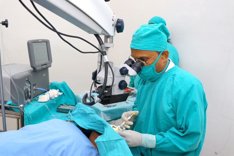 Surgeon operating at the microscope in Netrayu's operation theatre